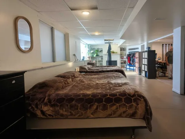 a bed sitting in a bedroom next to a window