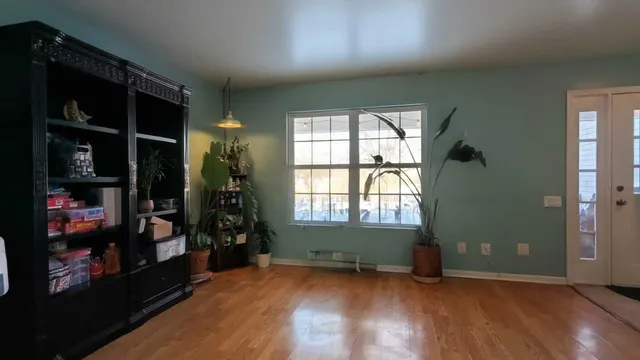 an empty room with wooden floor and closet