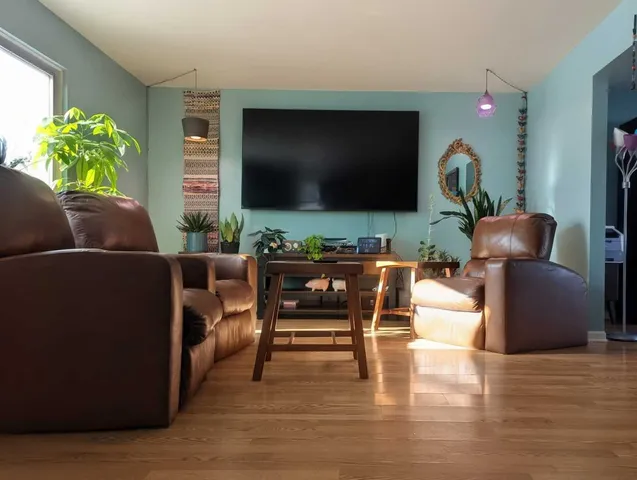 a living room with furniture and a flat screen tv