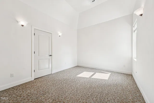 a aerial view of a house with a yard table and chairs