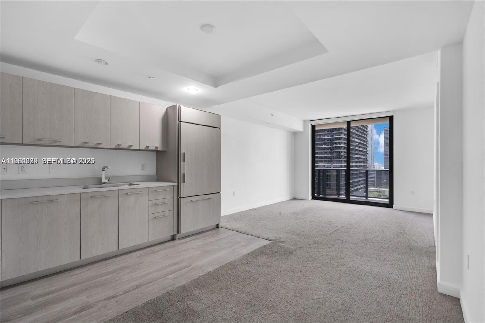 45 Southwest 9th Street, Unit 2204 Miami, FL 33130 - Photo 8 of 23 a view of an empty room with kitchen and a window