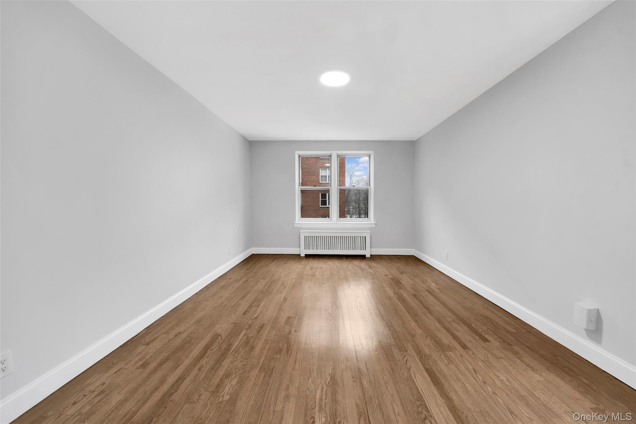 1 Vincent Road, Unit 2N Yonkers, NY 10708 - Photo 12 of 19 an empty room with wooden floor and windows