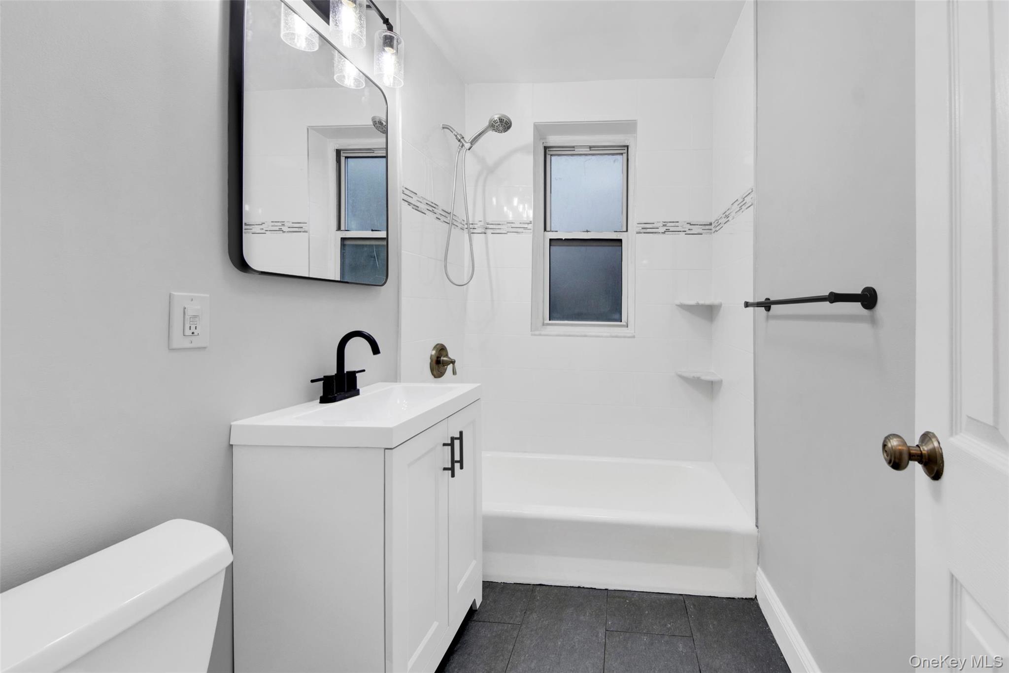 1 Vincent Road, Unit 2N Yonkers, NY 10708 - Photo 16 of 19 a bathroom with a sink a toilet and shower
