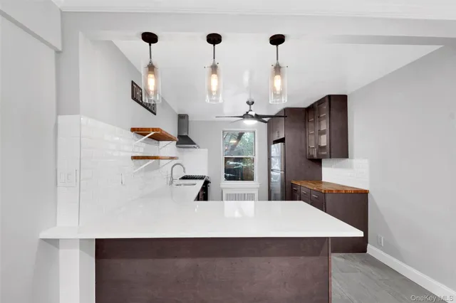 a kitchen with stainless steel appliances a sink a stove a refrigerator and cabinets