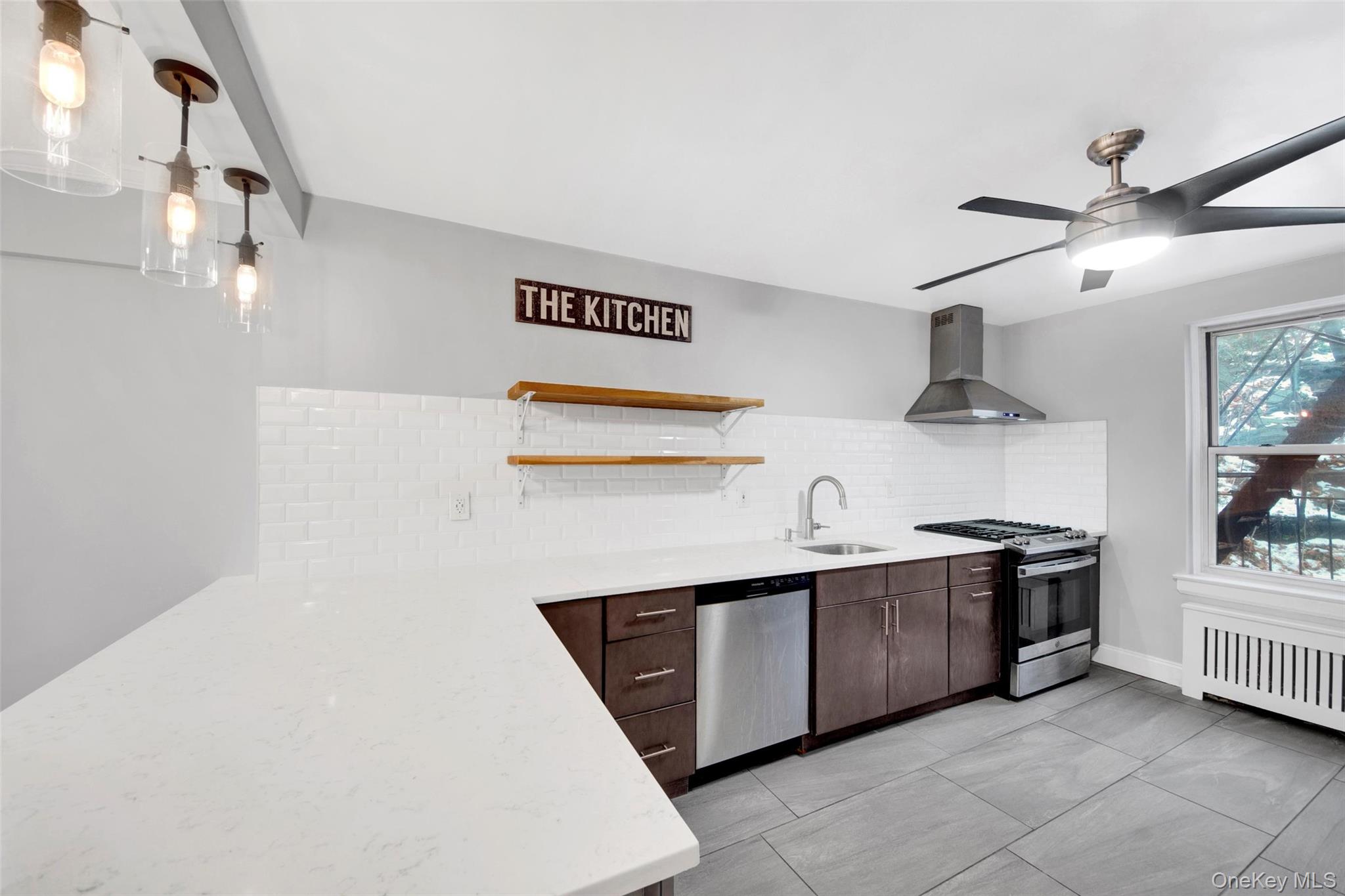 1 Vincent Road, Unit 2N Yonkers, NY 10708 - Photo 3 of 19 a kitchen with stainless steel appliances a sink a stove a refrigerator and cabinets