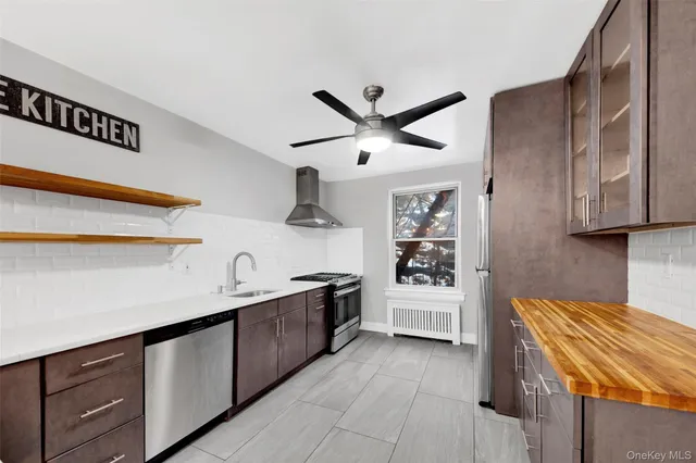 a kitchen with stainless steel appliances granite countertop a sink and wooden cabinets
