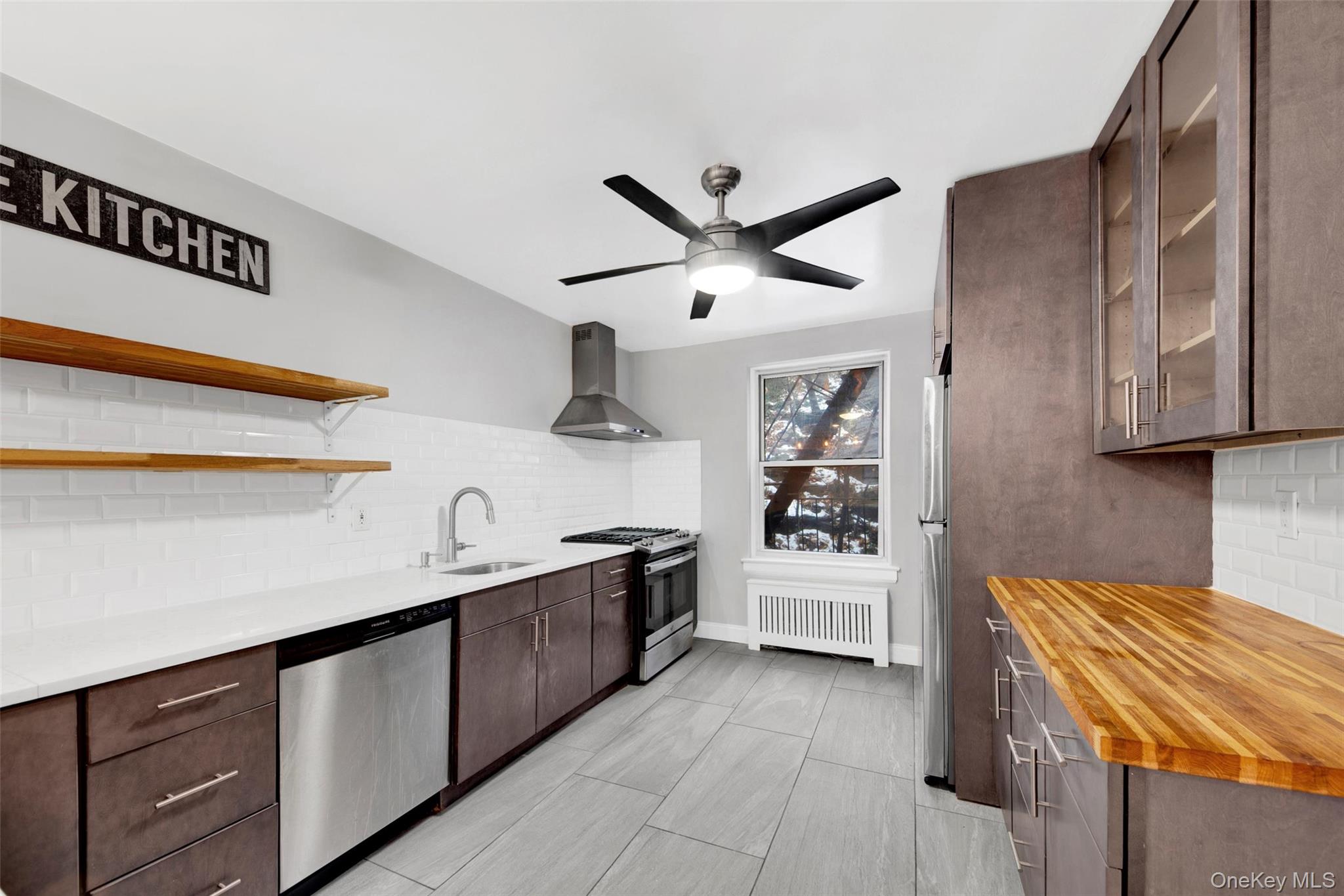 1 Vincent Road, Unit 2N Yonkers, NY 10708 - Photo 4 of 19 a kitchen with stainless steel appliances granite countertop a sink stove and cabinets