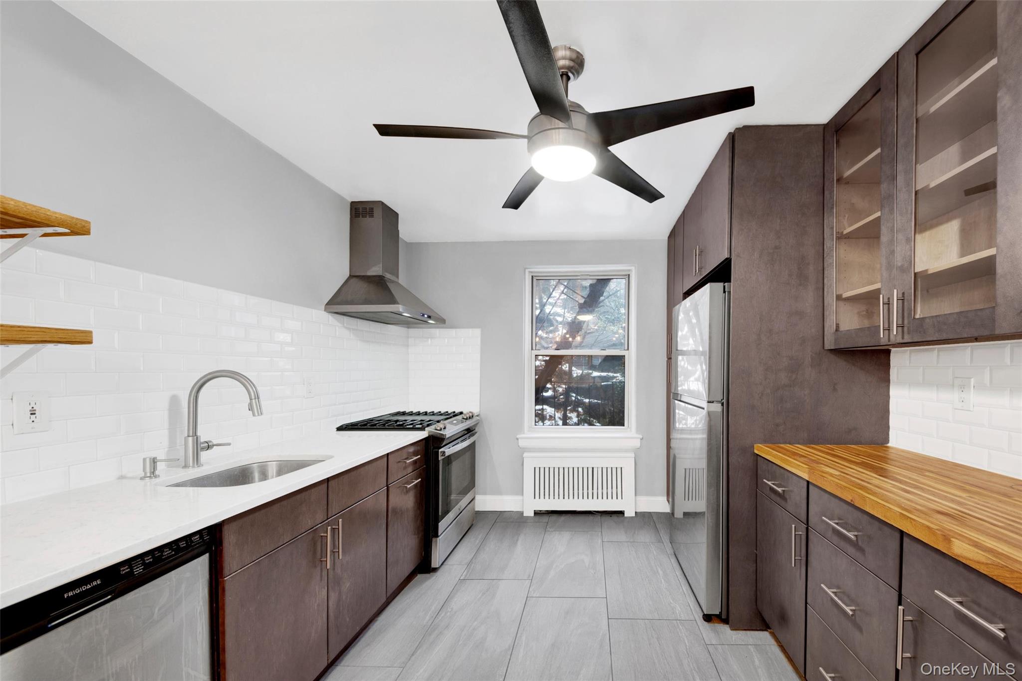 1 Vincent Road, Unit 2N Yonkers, NY 10708 - Photo 6 of 19 a kitchen with stainless steel appliances a sink and a stove
