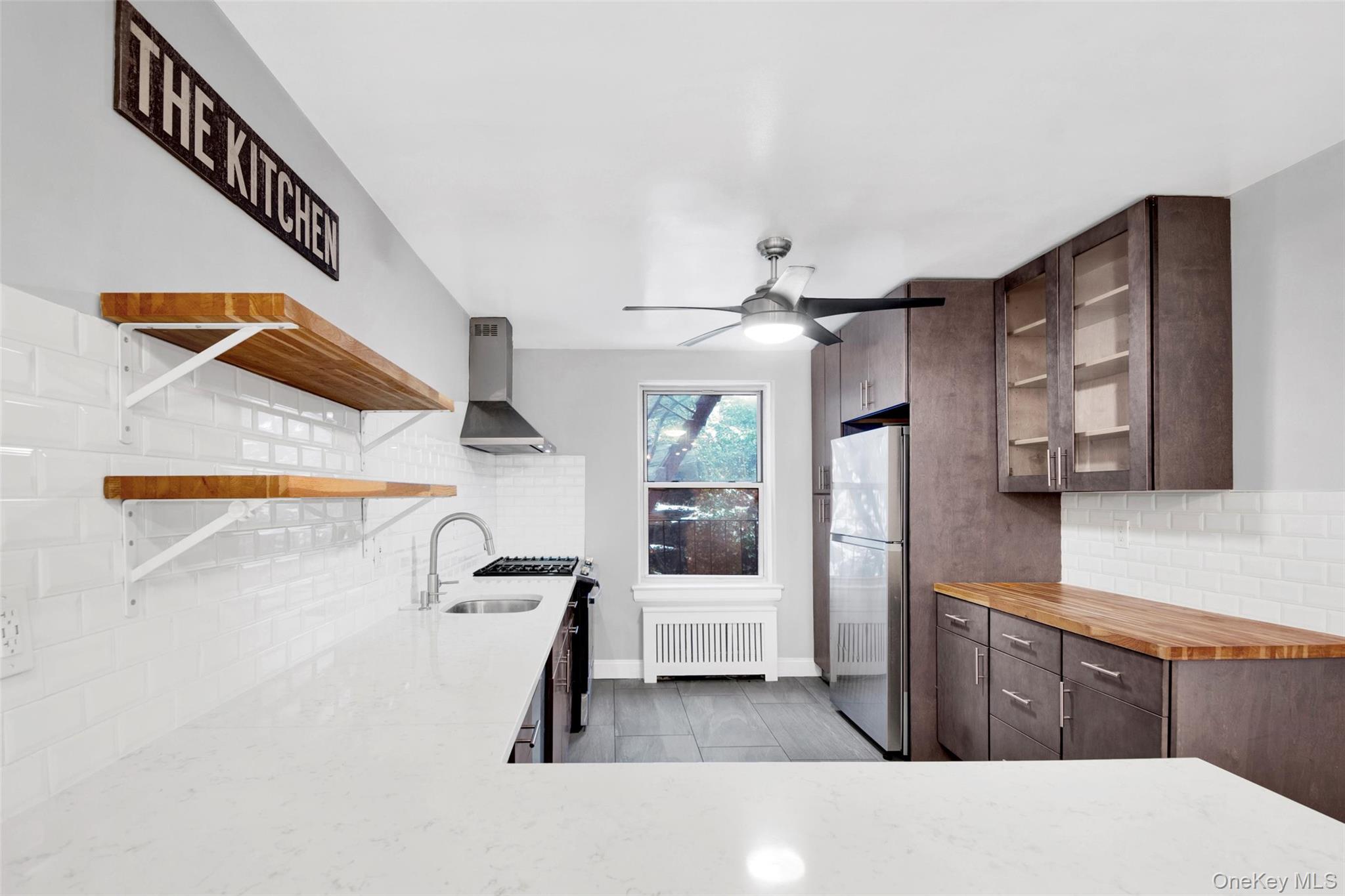 1 Vincent Road, Unit 2N Yonkers, NY 10708 - Photo 7 of 19 a kitchen with stainless steel appliances kitchen island granite countertop a refrigerator and a sink