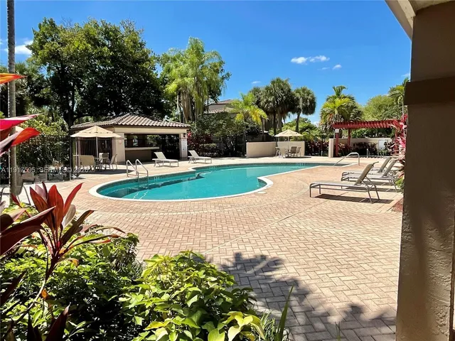 a view of a house with swimming pool and sitting area