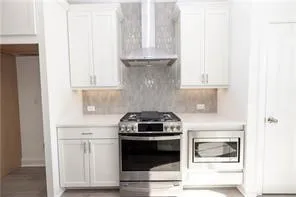 a stove top oven sitting inside of a kitchen