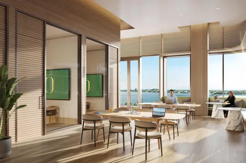 a living room with furniture and floor to ceiling windows