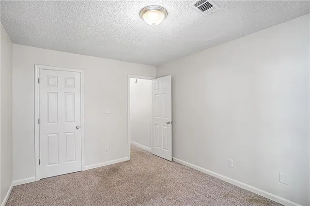 an empty room with closet area