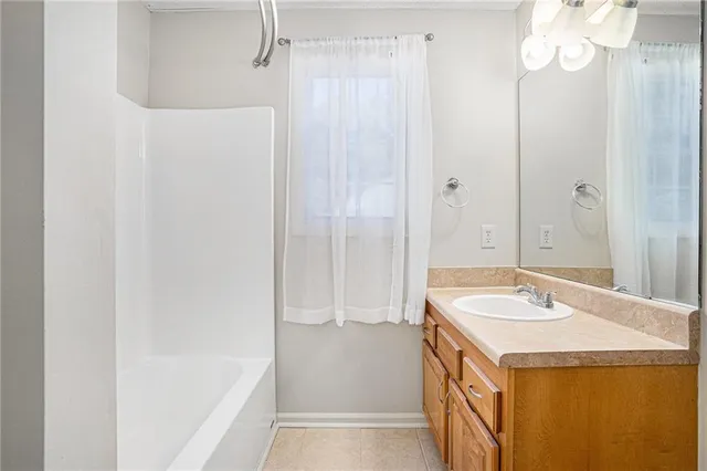 a bathroom with a sink a mirror and a bathtub