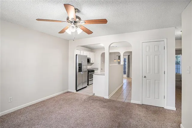 a view of a livingroom with a chandelier fan