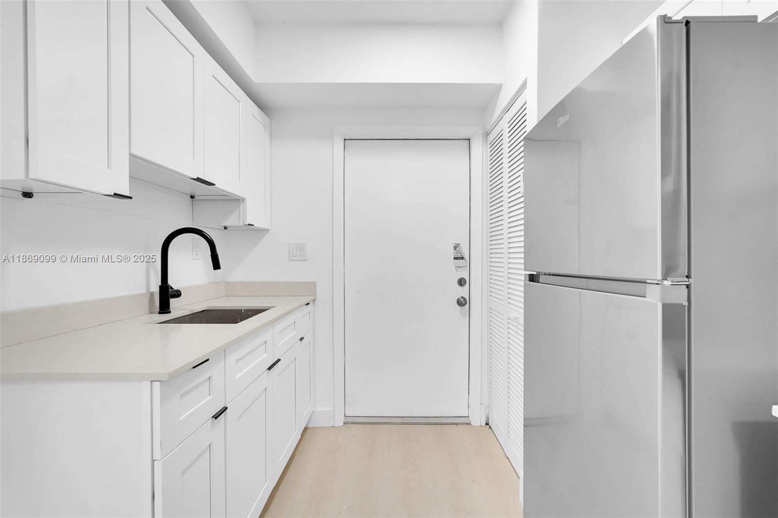 1814 Northwest 2nd Court, Unit 2 Miami, FL 33136 - Photo 10 of 13 a kitchen with a sink and a refrigerator