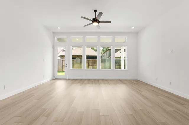 a view of kitchen with stainless steel appliances granite countertop a stove top oven a sink and a refrigerator