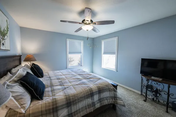 a bedroom with a bed and a flat screen tv
