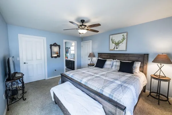 a bedroom with a bed and a chandelier