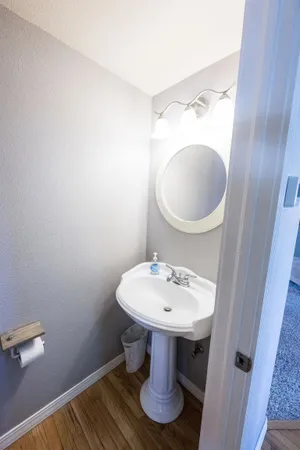 a bathroom with a sink toilet and a mirror