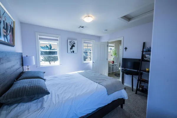 a bedroom with a bed and window