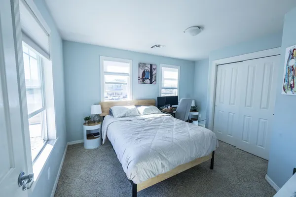 a bedroom with a bed and a window