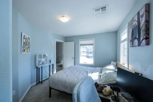 a bedroom with a bed and a window