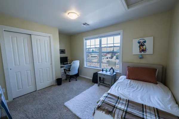 a bedroom with furniture and a window
