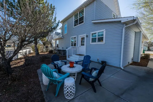 a backyard of a house with table and chairs
