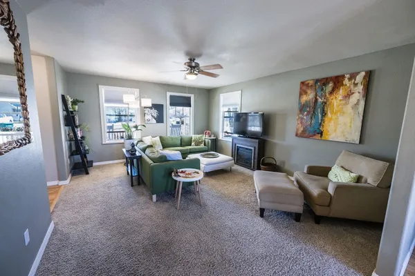a living room with furniture and a chandelier