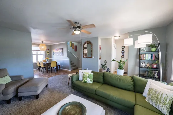a living room with furniture and wooden floor