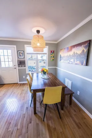a view of a dining room with furniture and wooden floor