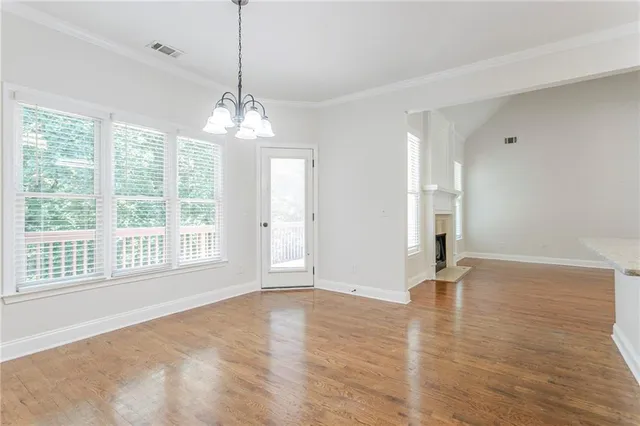 an empty room with a ceiling fan and a window
