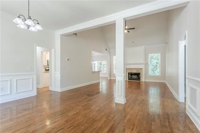 a view of a livingroom with wooden floor and a ceiling fan