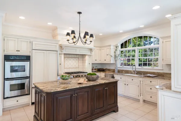 a kitchen with a sink stove and cabinets
