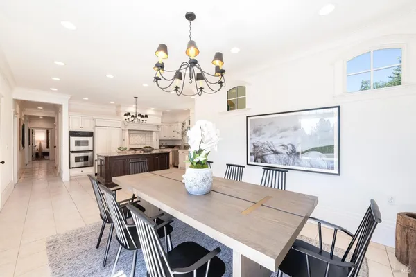 a view of a dining room with furniture and chandelier