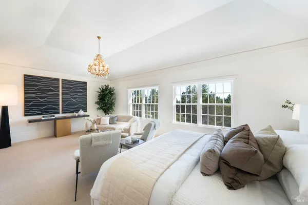 a spacious bedroom with a bed and a large window