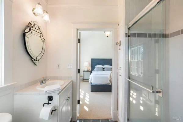 a en suite bathroom with a sink a mirror and a shower