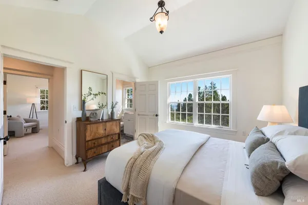 a bedroom with bed and a large window