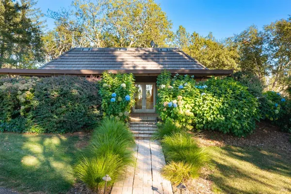 a view of house with a yard