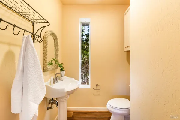 a bathroom with a sink toilet and mirror