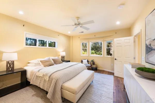 a bedroom with a large bed and a window
