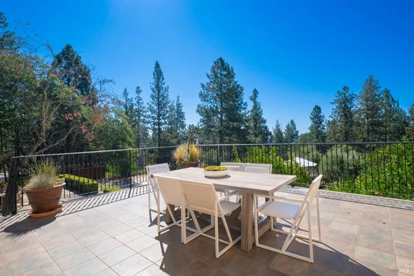 a view of a table and chairs on the roof deck