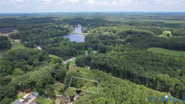 an aerial view of residential houses with outdoor space and trees
