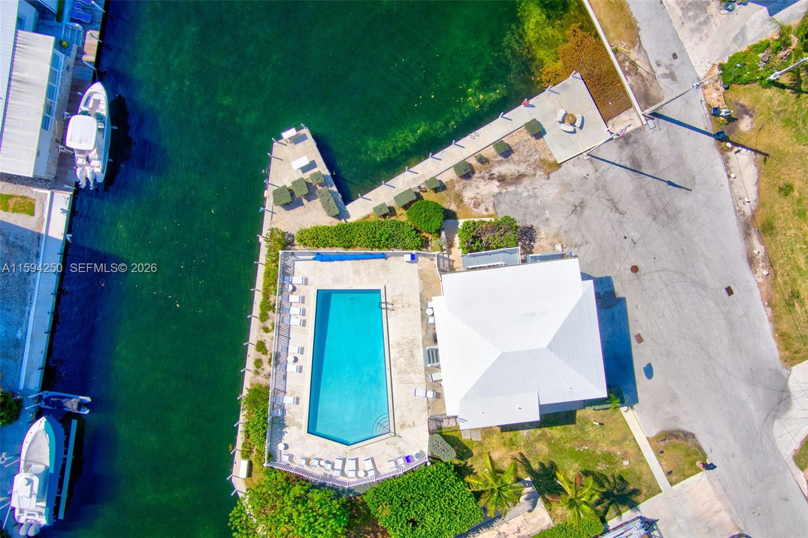 84 Coral Way Key Largo, FL 33037 - Photo 49 of 55 an aerial view of a house with outdoor space pool seating area and fire pit