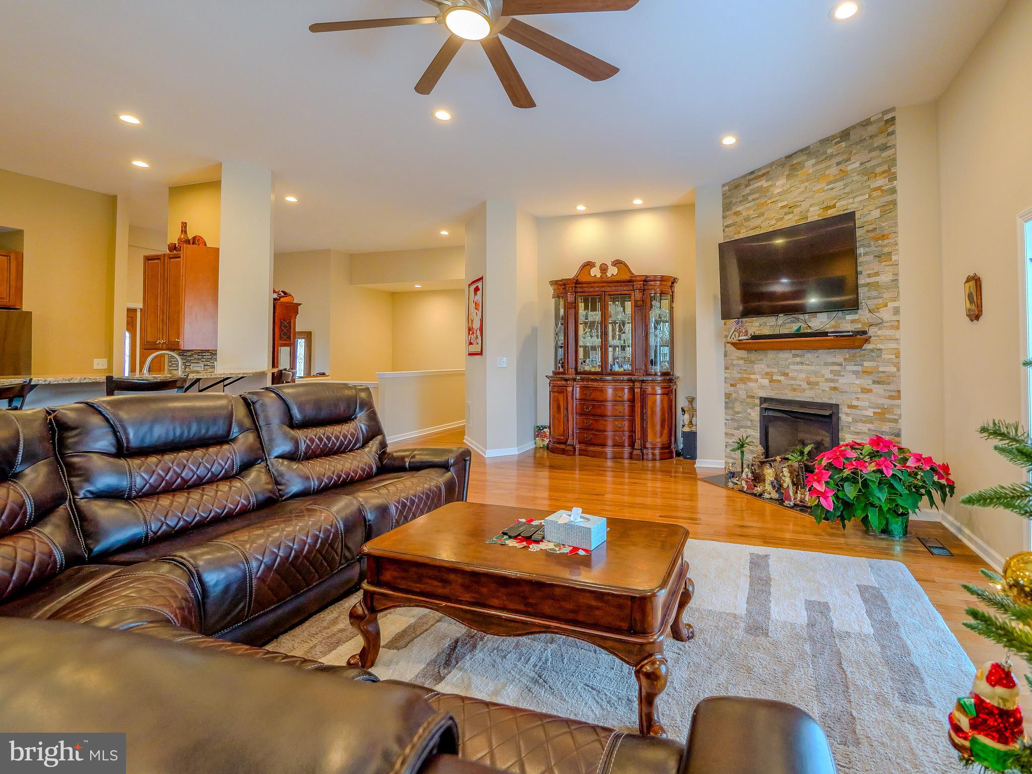 559 Franklinville Road Mullica Hill, NJ 08062 - Photo 11 of 41 a living room with furniture a flat screen tv and a fireplace
