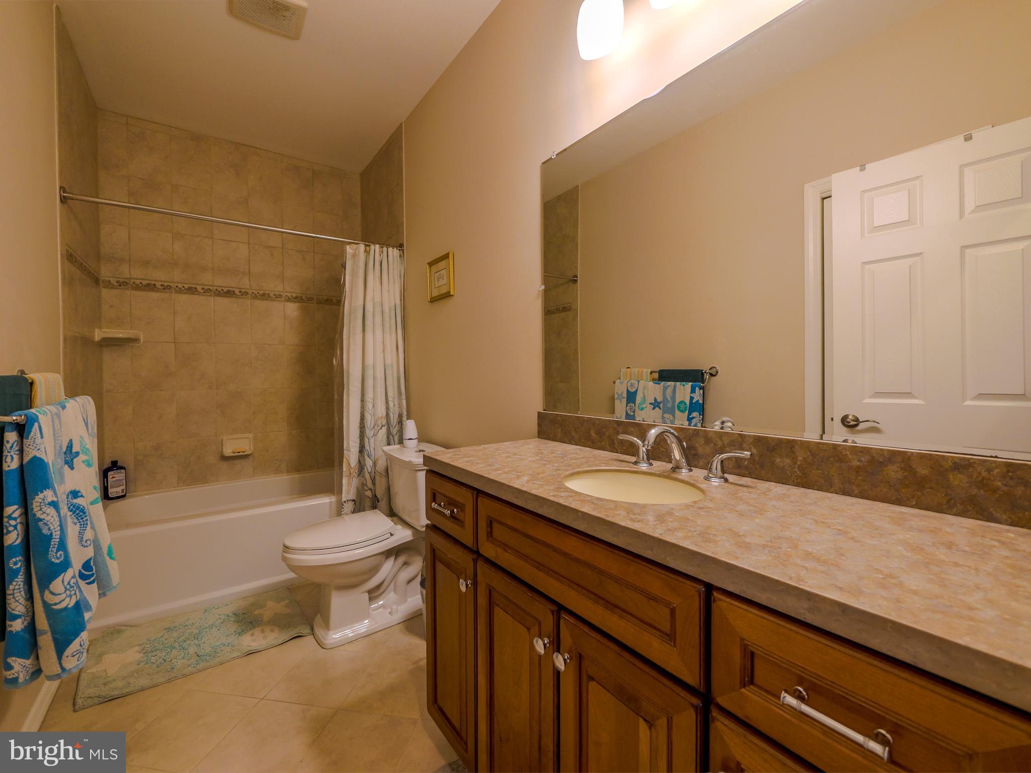 559 Franklinville Road Mullica Hill, NJ 08062 - Photo 22 of 41 a bathroom with a granite countertop sink toilet mirror vanity and bathtub