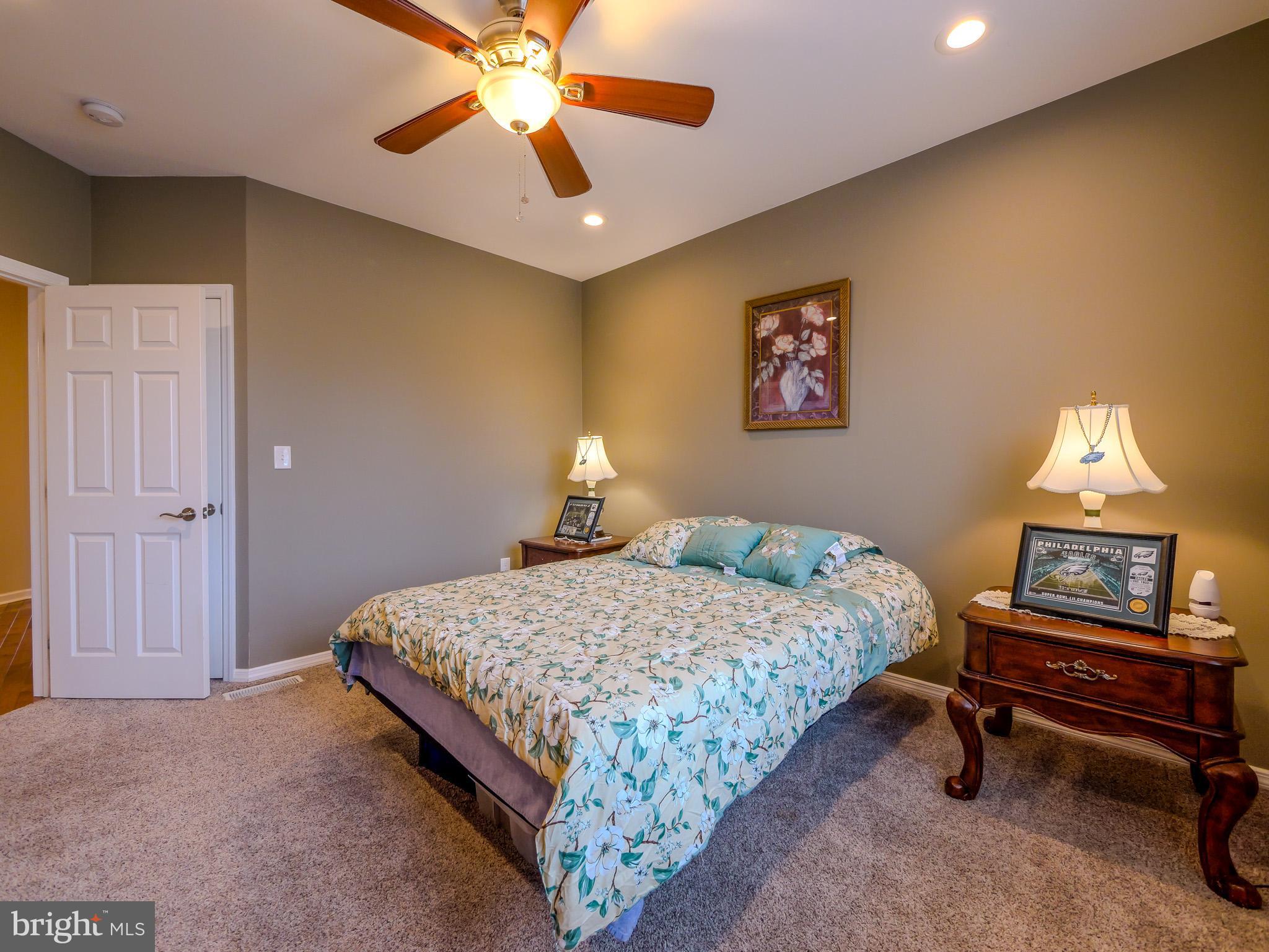 559 Franklinville Road Mullica Hill, NJ 08062 - Photo 26 of 41 a bedroom with a bed and a chandelier