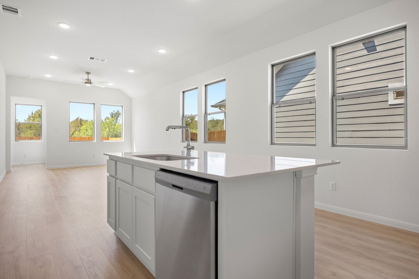 278 Bendecido Loop Elgin, TX 78621 - Photo 12 of 37 a kitchen with stainless steel appliances granite countertop a sink and wooden cabinets