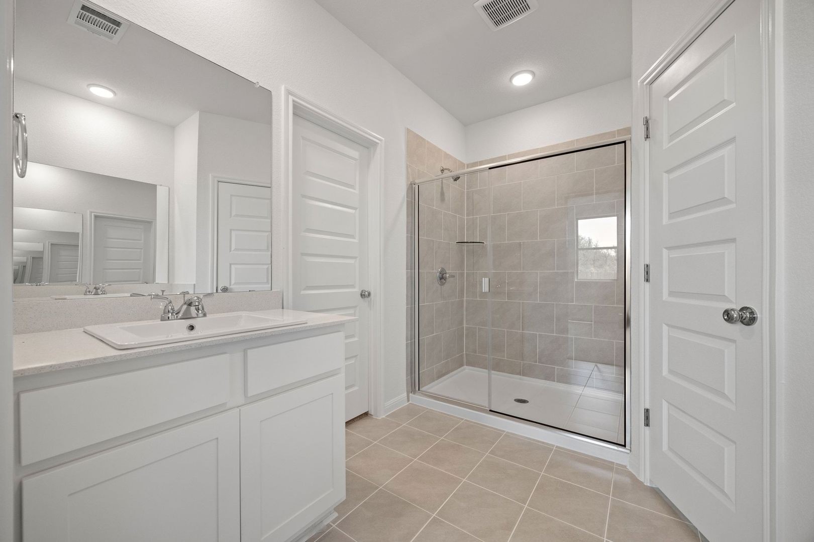 278 Bendecido Loop Elgin, TX 78621 - Photo 15 of 37 a bathroom with a shower sink and mirror